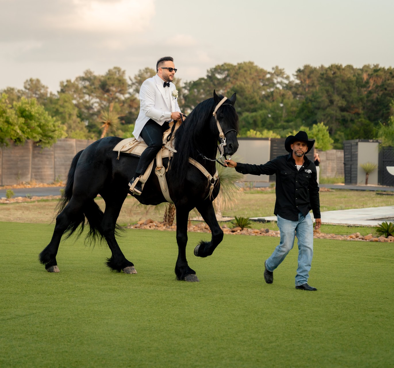 Groom arriving on black horse at AG Outdoor Venue