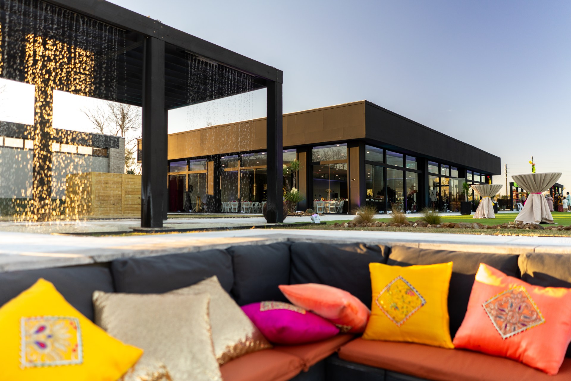 Venue exterior with water curtain pergola at dusk