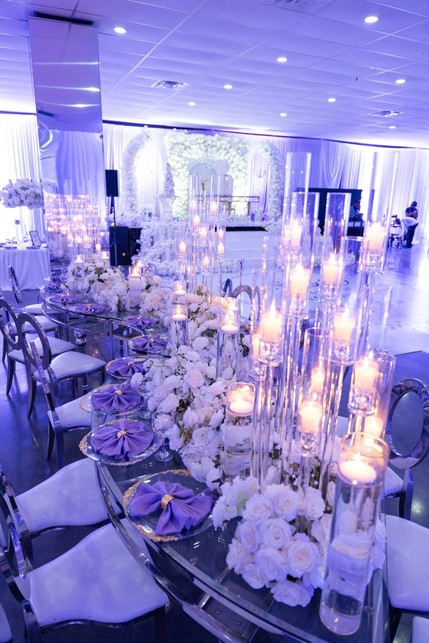 Elegant candlelit reception hall with white roses