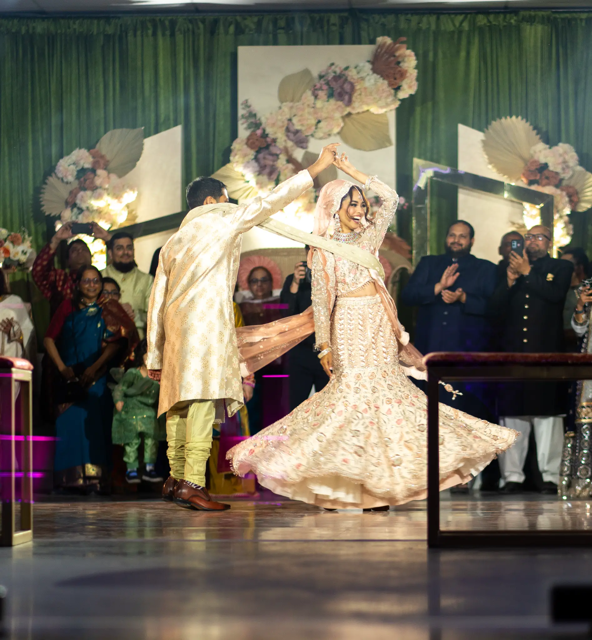 Indian bride spinning in embroidered lehenga during first dance