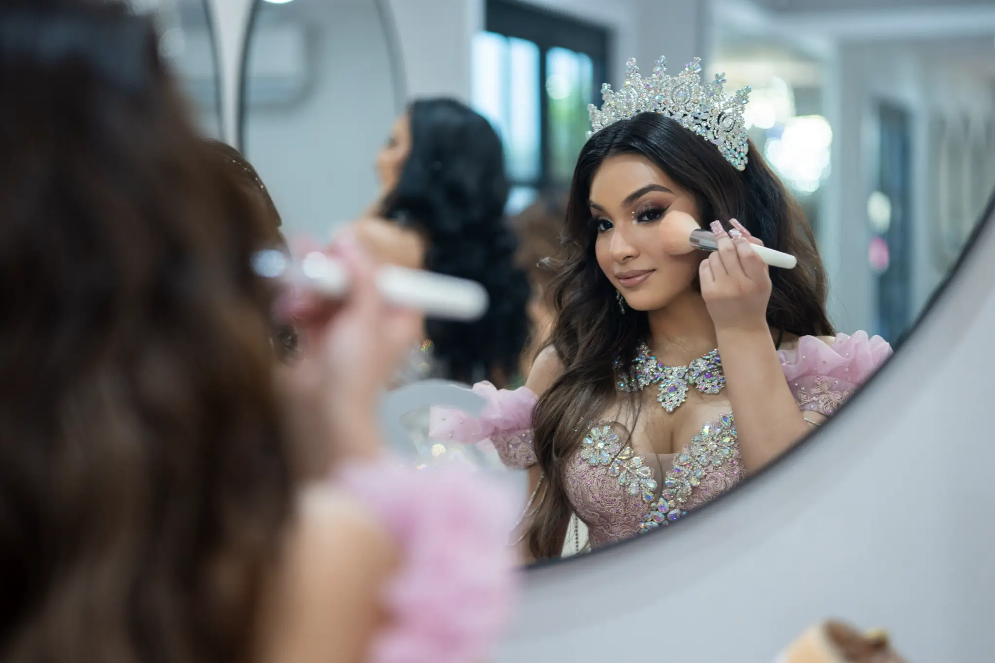 Quinceañera with crystal crown getting ready