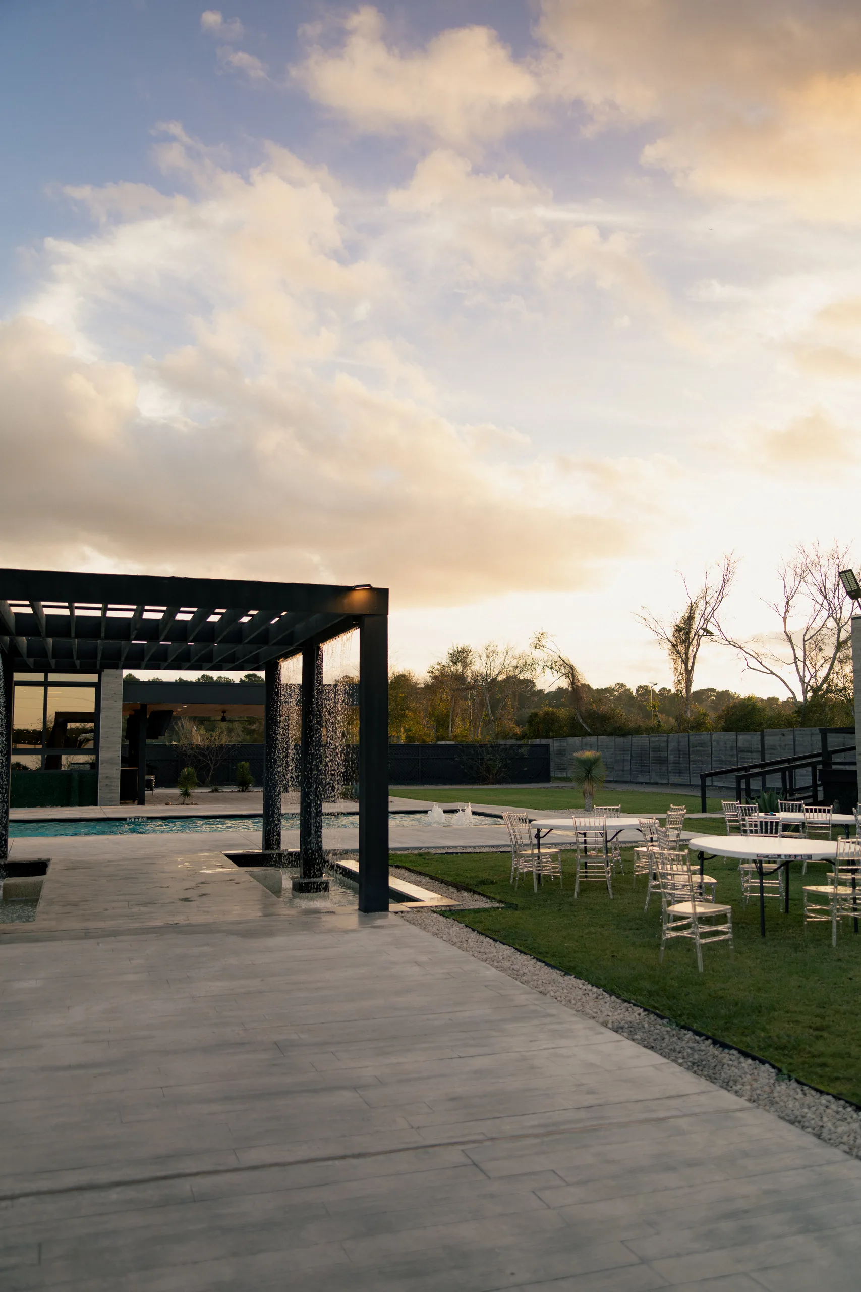 Outdoor courtyard, pergola, water feature, and lawn at AG Outdoor Venue in Tomball, Texas